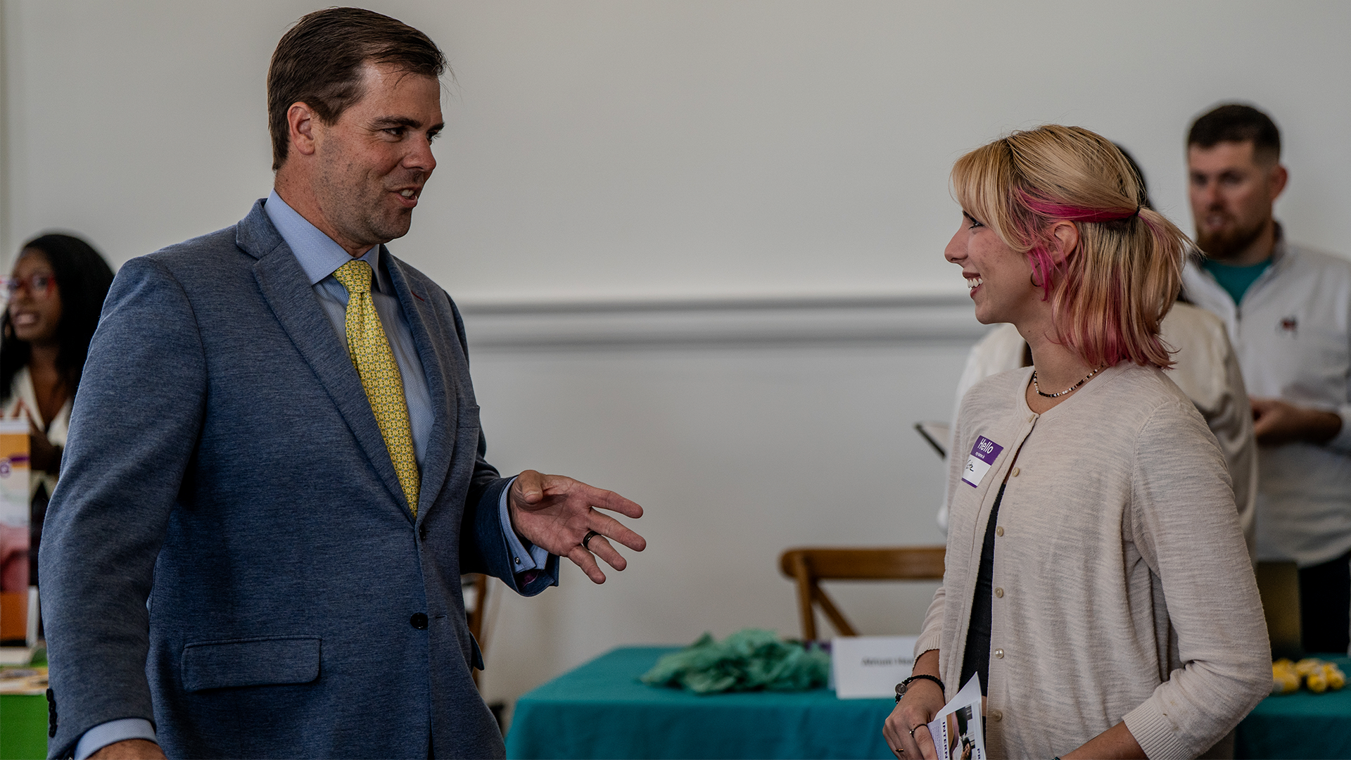 Eagle Scout Scholarship Female student engaging in conversation with businessman