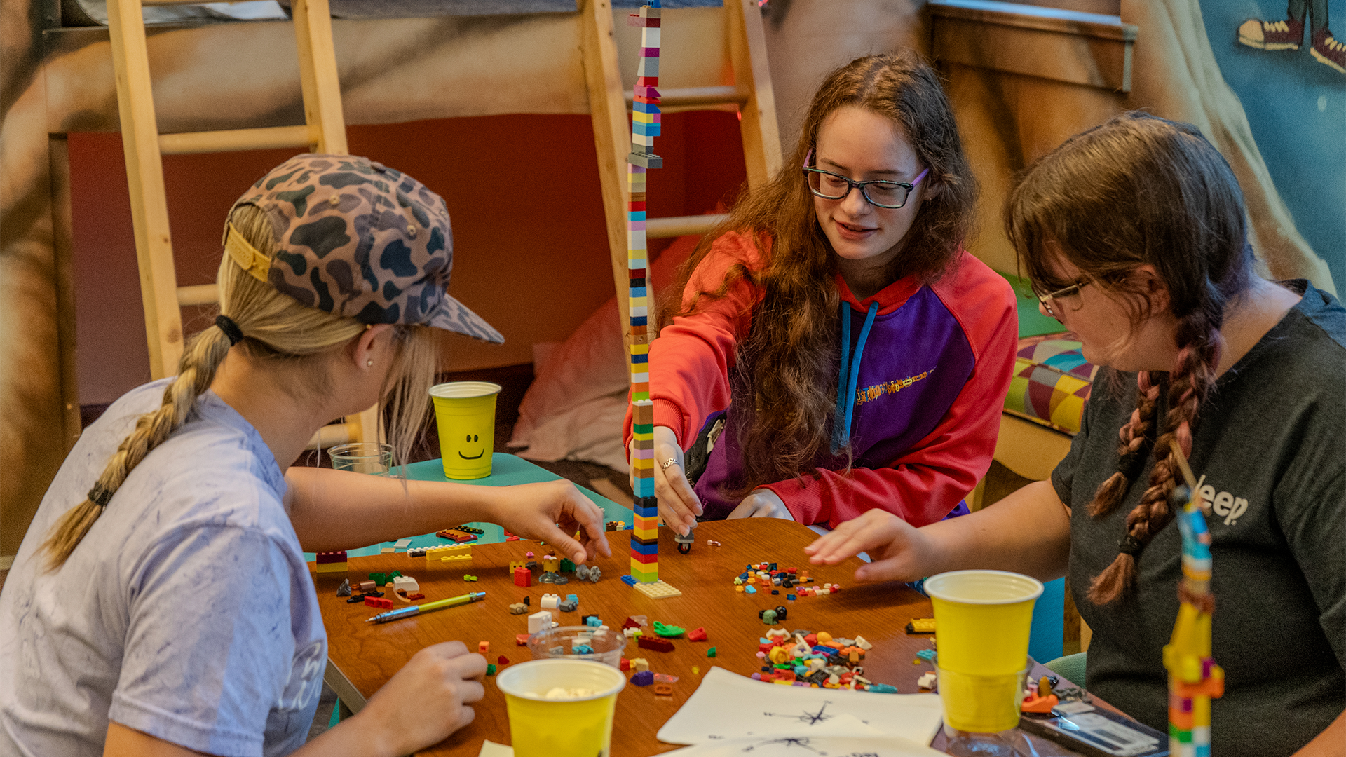 Lane Scholarship Photo Students around a table creating a project out of LEGO blocks