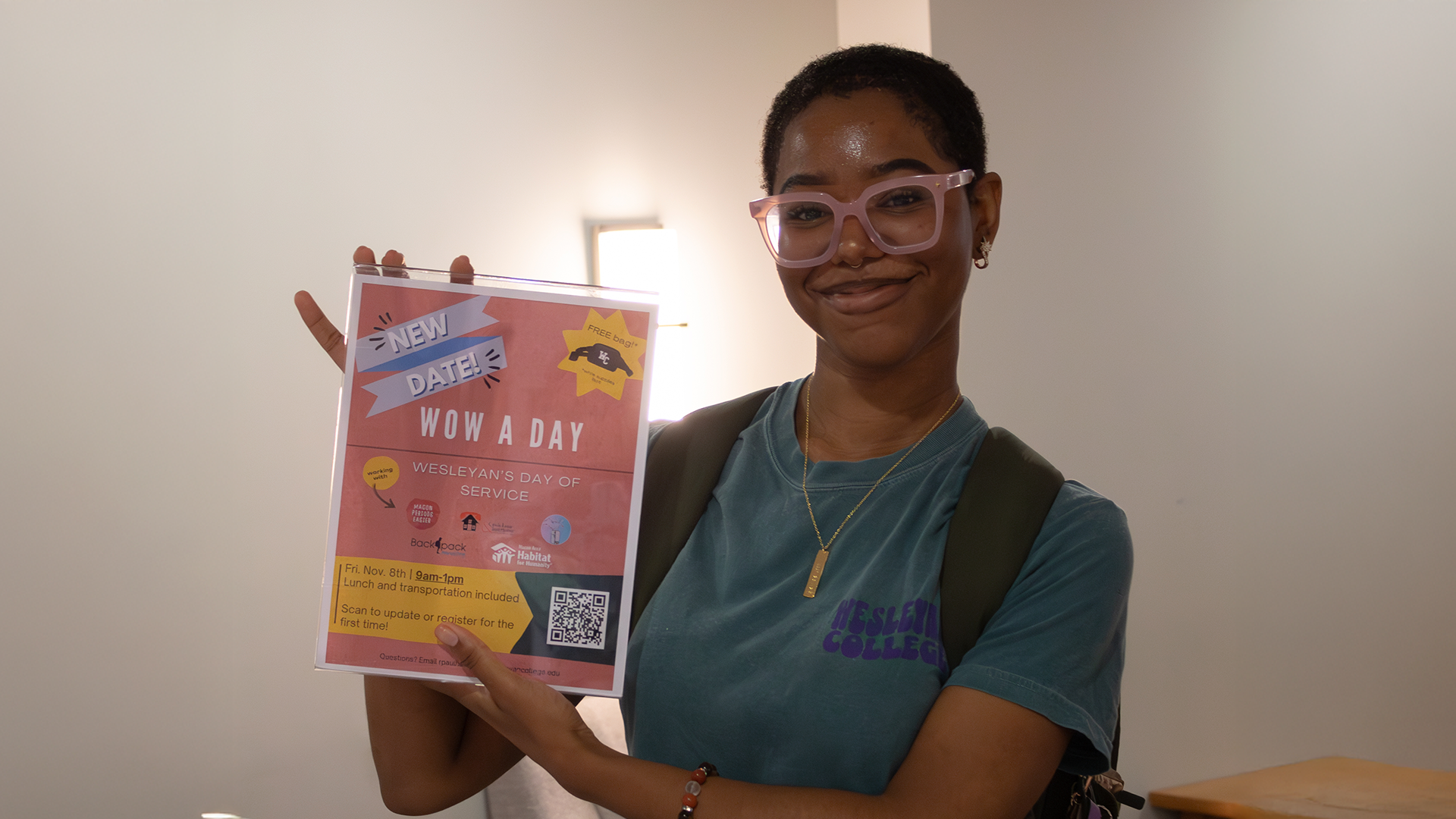 McNeill Scholarship Photo Student holding up a sign promoting a community service event