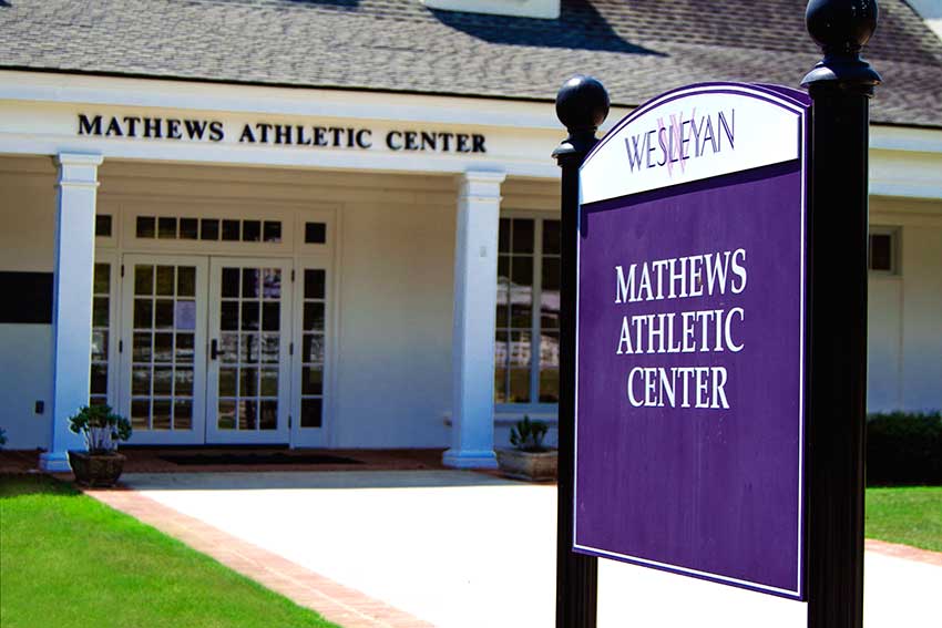 Sign of Mathews Athletic Center with the building behind it